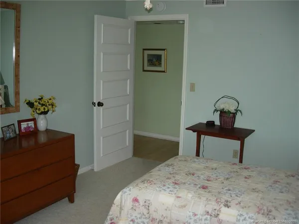 a bedroom with a bed and a dresser