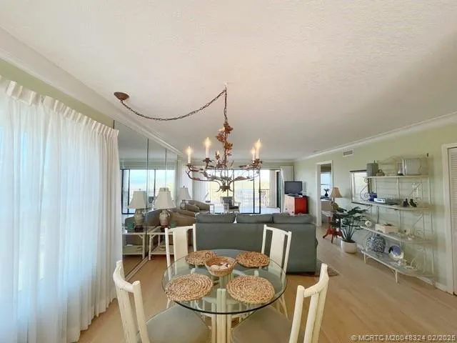 a kitchen with stainless steel appliances kitchen island granite countertop a table and chairs in it
