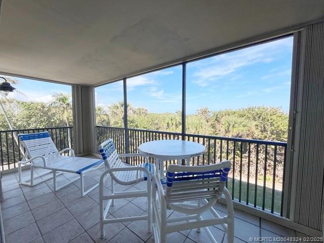 2641 Northeast Ocean Boulevard, Unit 201 Stuart, FL 34996 - Photo 14 of 34 a view of a balcony with chair and table