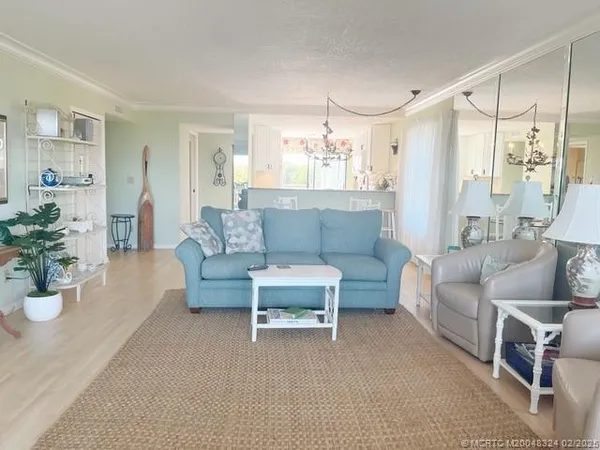 a living room with furniture and a chandelier
