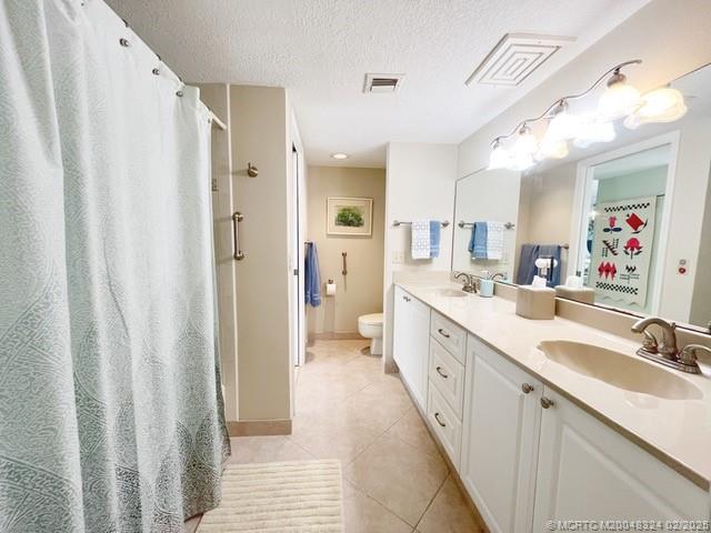 2641 Northeast Ocean Boulevard, Unit 201 Stuart, FL 34996 - Photo 30 of 34 a spacious bathroom with a double vanity sink and mirror