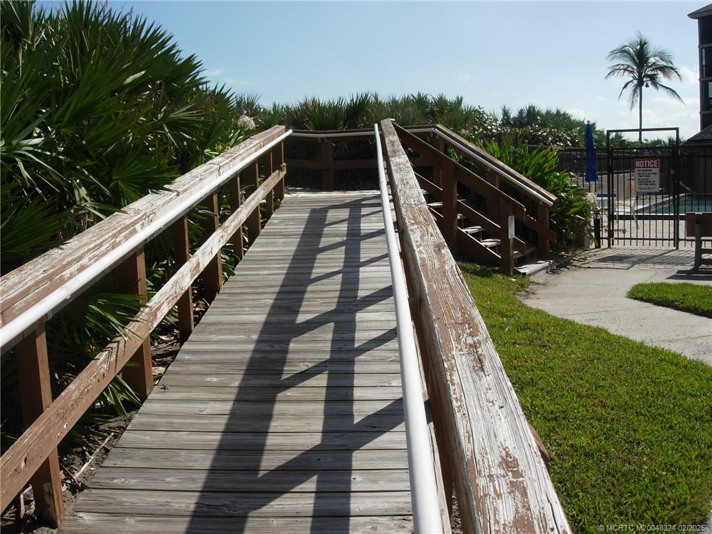 2641 Northeast Ocean Boulevard, Unit 201 Stuart, FL 34996 - Photo 7 of 34 a view of balcony with wooden floor and fence
