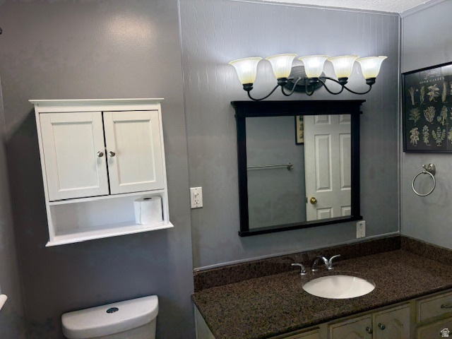 2313 150 East Bountiful, UT 84010 - Photo 21 of 39 Vanity area featuring a dark countertop, white undermount sink, and a framed mirror with a five-light fixture