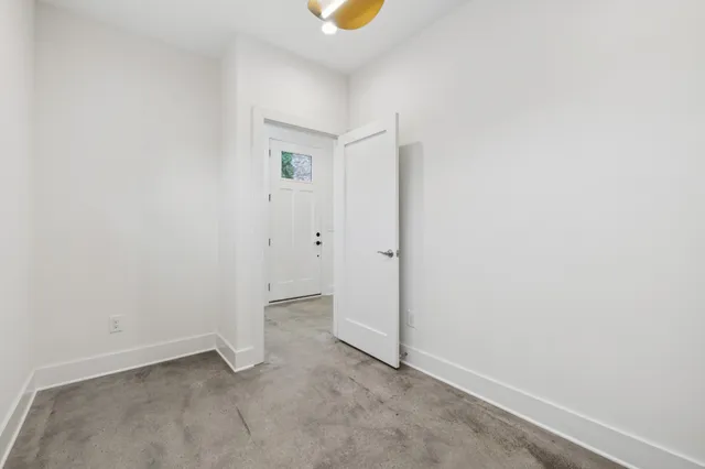 a view of staircase with white walls and railing