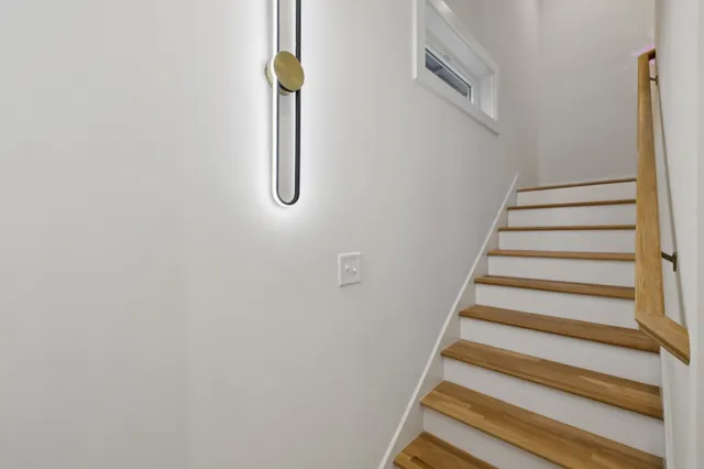 a kitchen with kitchen island a sink stainless steel appliances and chandelier