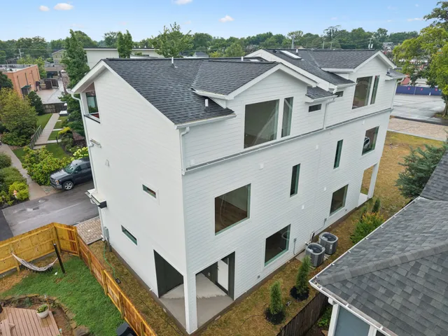 a view of a house with pool and wooden fence