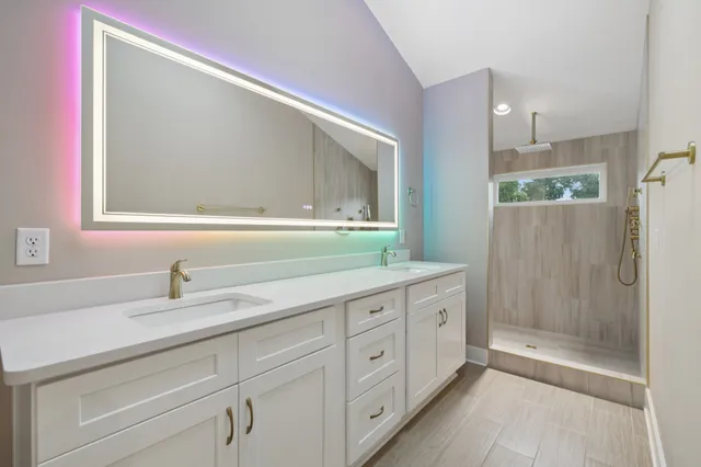 a bathroom with a double vanity sink and mirror