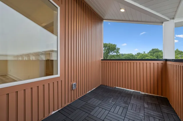 a view of a porch with wooden floor and fence