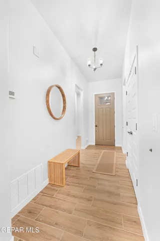 a bathroom with a granite countertop toilet sink and mirror