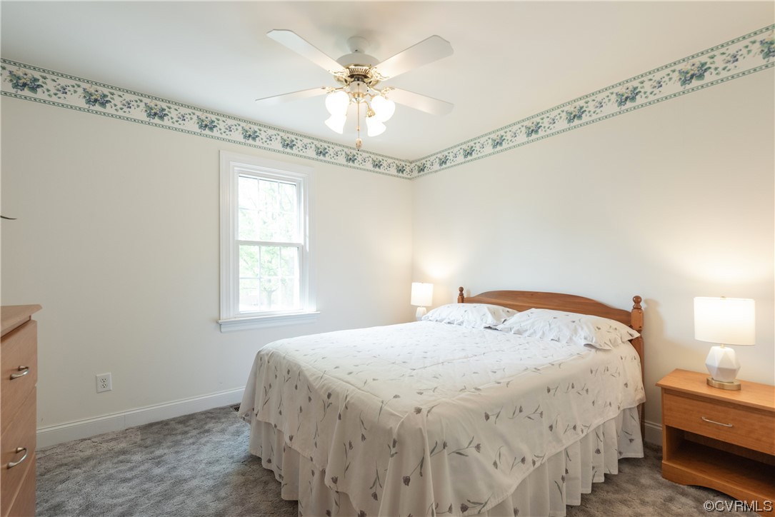 7508 Donder Road Richmond, VA 23294 - Photo 18 of 38 a bedroom with a bed and a chandelier