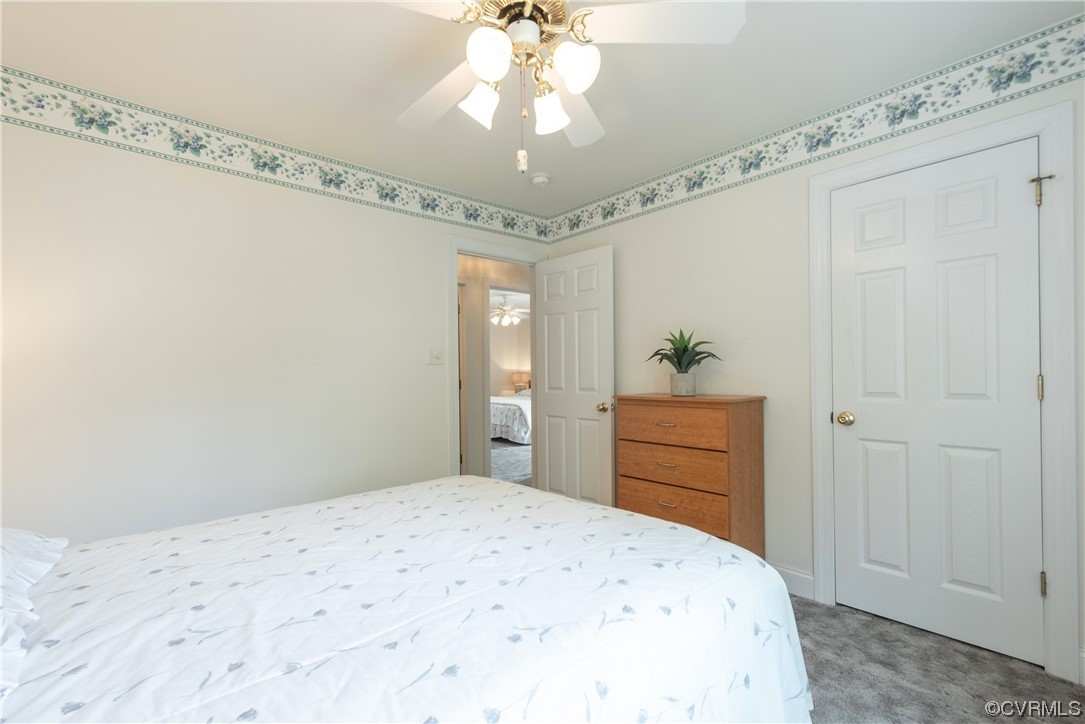 7508 Donder Road Richmond, VA 23294 - Photo 19 of 38 a bedroom with a bed and a chandelier