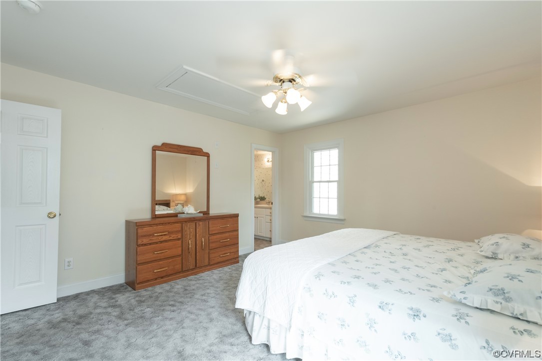 7508 Donder Road Richmond, VA 23294 - Photo 23 of 38 a spacious bedroom with a bed and a chandelier