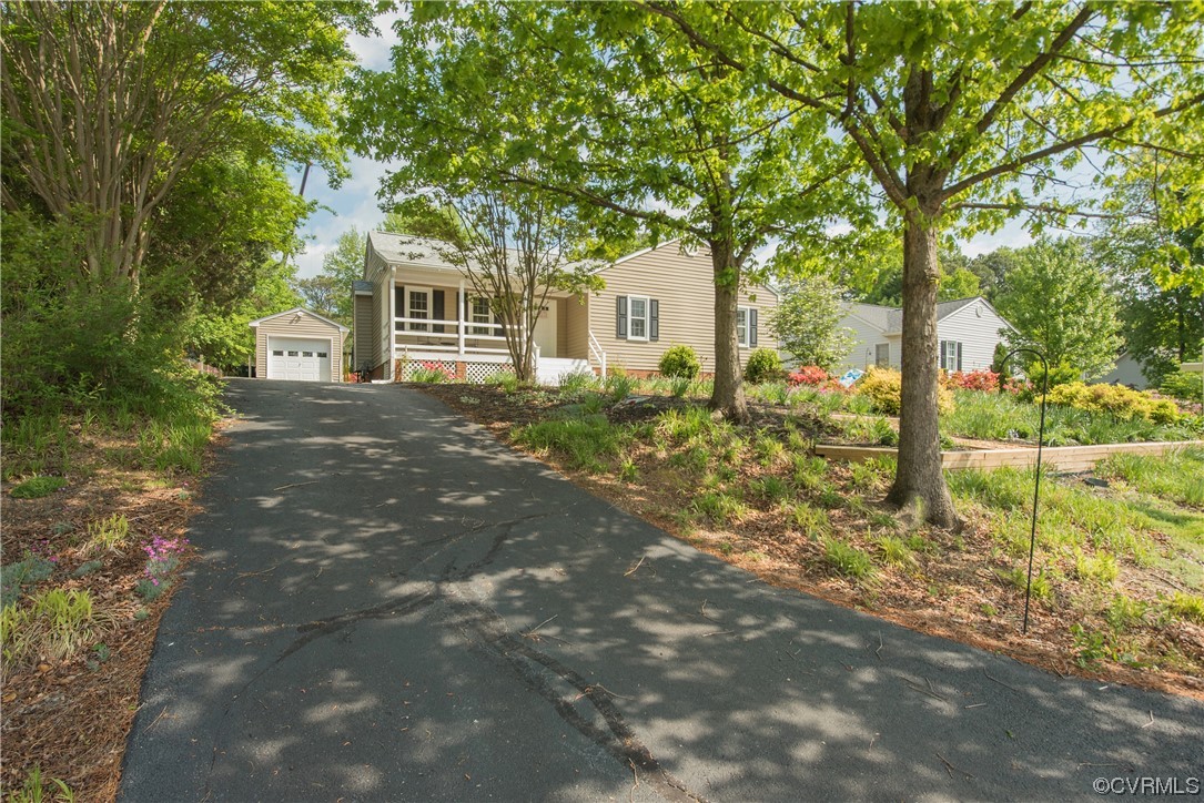 7508 Donder Road Richmond, VA 23294 - Photo 27 of 38 a front view of a house with a garden