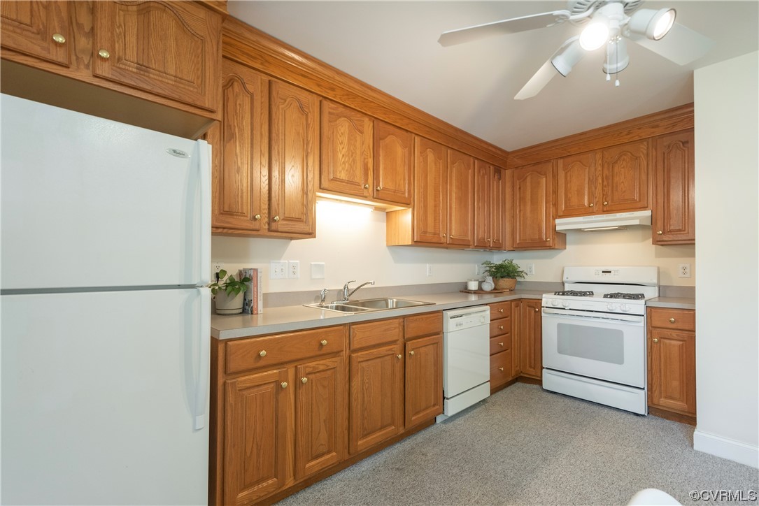 7508 Donder Road Richmond, VA 23294 - Photo 9 of 38 a kitchen with a sink a refrigerator and cabinets