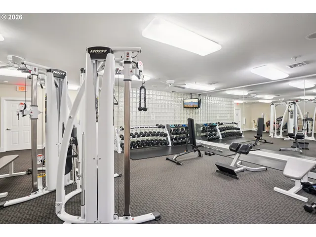 a living room with lots of chairs and mirrors
