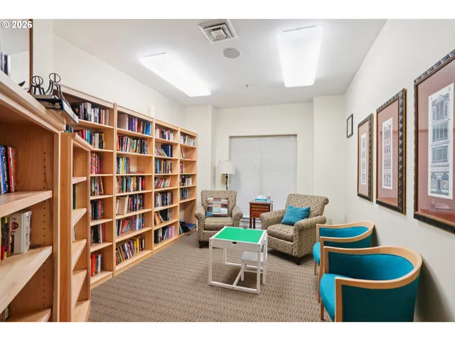 a living room with furniture and a book shelf
