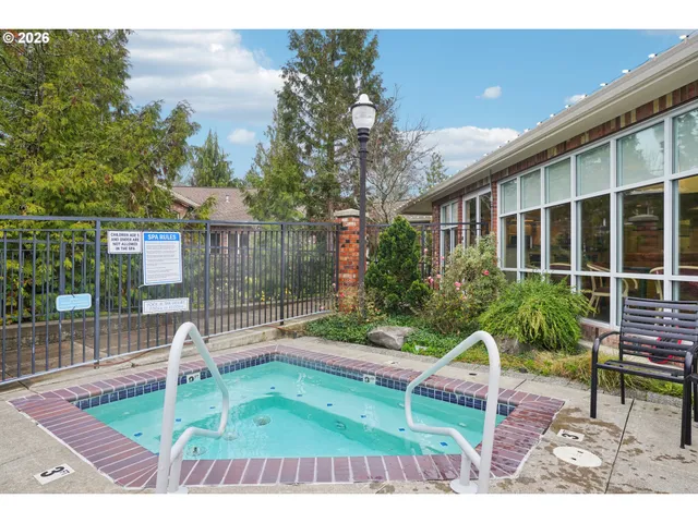 a view of a chair and table in backyard of the house