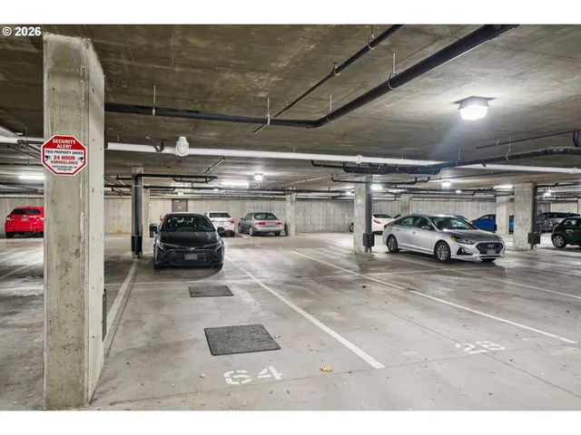 a view of parking garage with cars