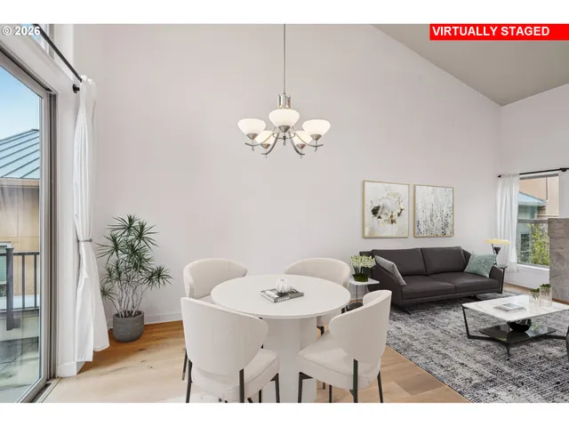 a living room with furniture flowerpot and a chandelier