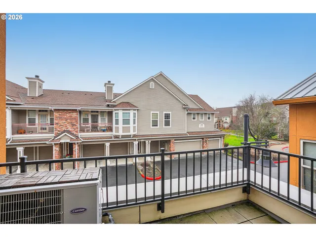 a view of a house with wooden fence