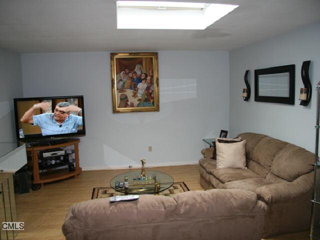 737 Cove Road, Unit 2A Stamford, CT 06902 - Photo 1 of 1 a living room with furniture and a flat screen tv