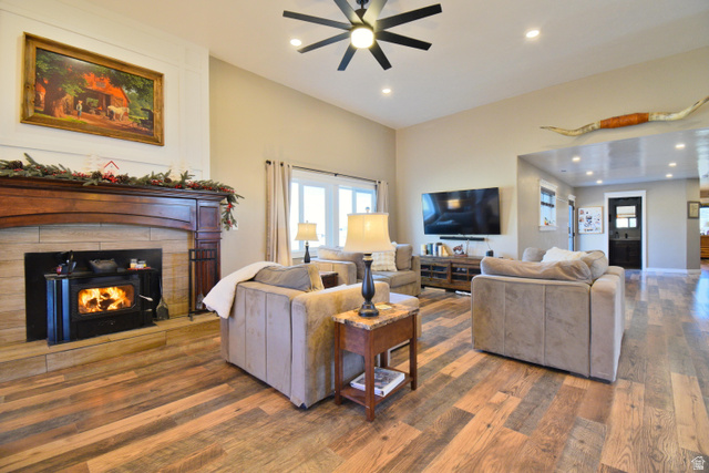 656 South Bullion Canyon Road Marysvale, UT 84750 - Photo 15 of 57 Living room with hardwood / wood-style floors, a warm lit fireplace, a ceiling fan, and recessed lighting