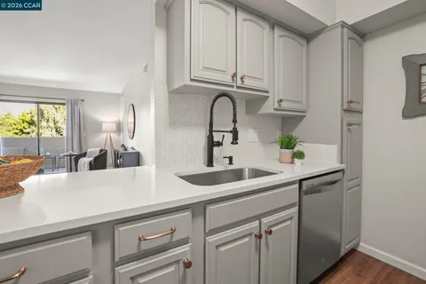 a kitchen with stainless steel appliances a sink and cabinets