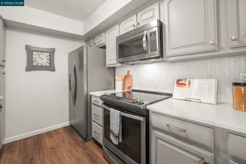 a kitchen with stainless steel appliances granite countertop a stove and a microwave