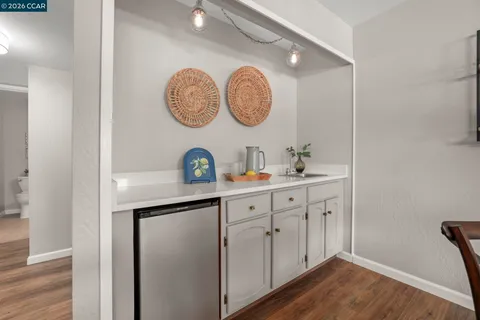 a bathroom with a sink and a clock on the wall