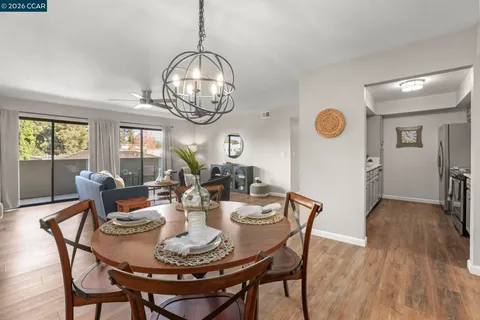 a view of a dining room with furniture wooden floor and chandelier
