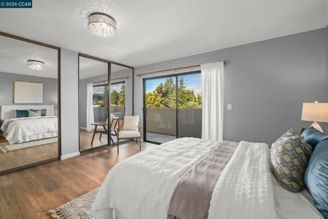a bedroom with a large bed and a chandelier