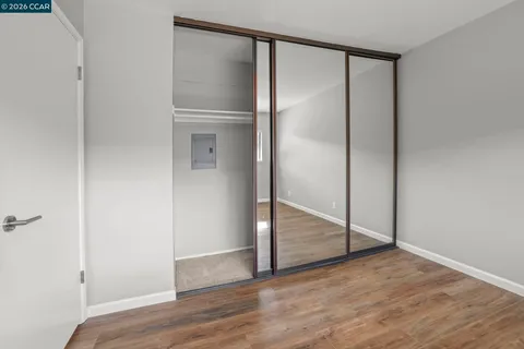 a view of empty room with wooden floor