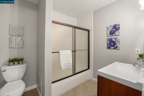 a bathroom with a sink mirror vanity and toilet