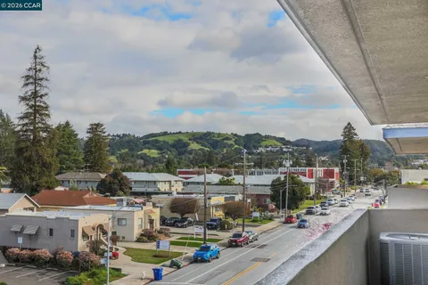a view of balcony with wooden floor and seating space
