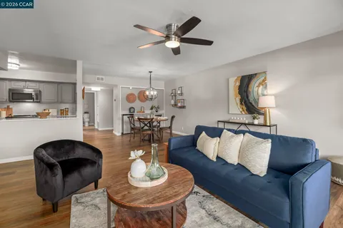 a living room with furniture and kitchen view