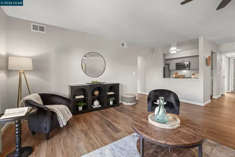 a bedroom with furniture and wooden floor
