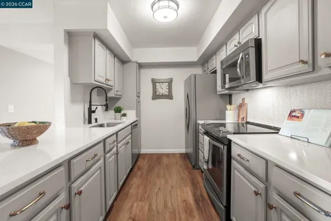 a kitchen with stainless steel appliances granite countertop lots of counter space sink and cabinets