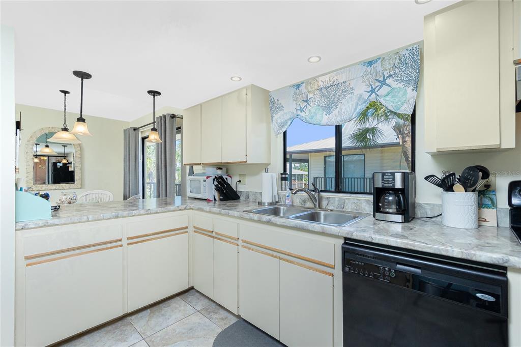 2450 North Beach Road, Unit 231 Englewood, FL 34223 - Photo 17 of 54 a kitchen with a sink and cabinets