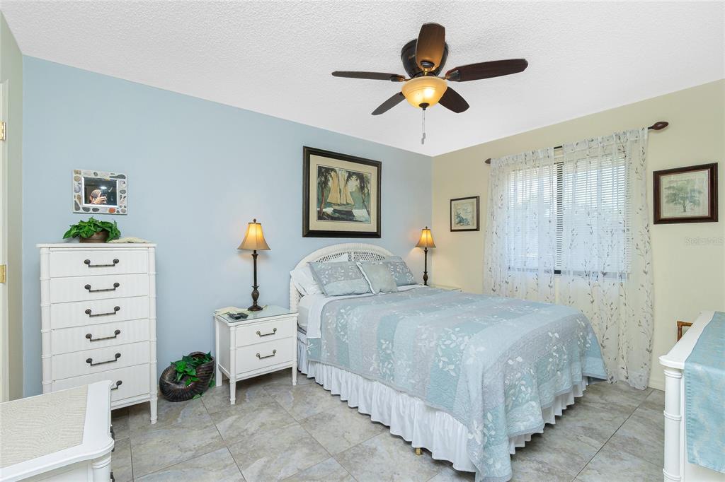 2450 North Beach Road, Unit 231 Englewood, FL 34223 - Photo 19 of 54 a bedroom with a bed and a chandelier