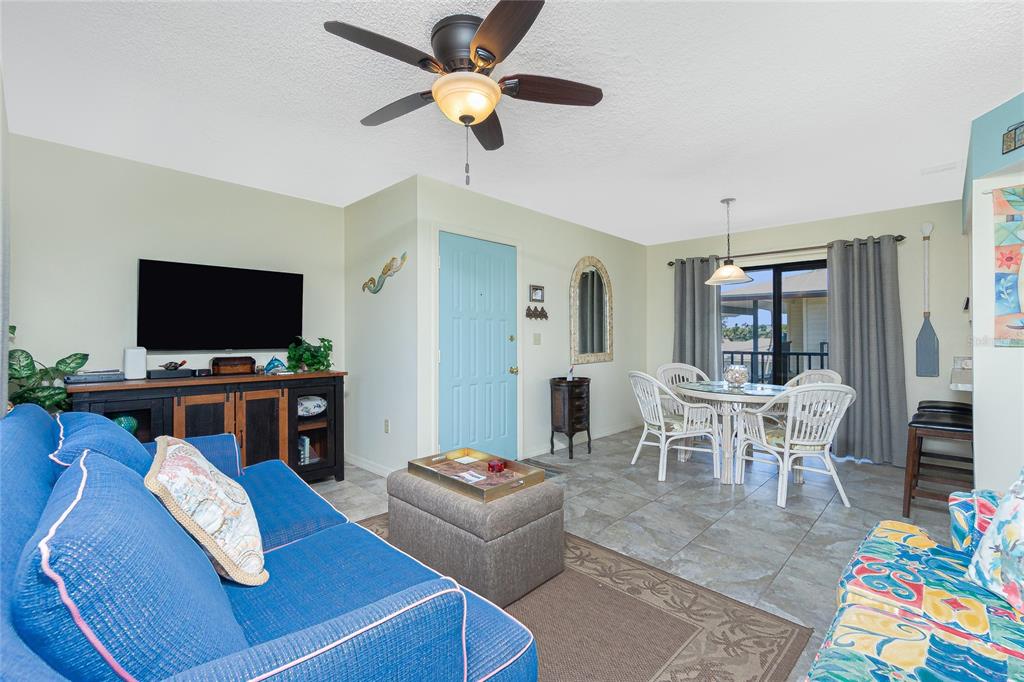 2450 North Beach Road, Unit 231 Englewood, FL 34223 - Photo 3 of 54 a living room with furniture and a flat screen tv