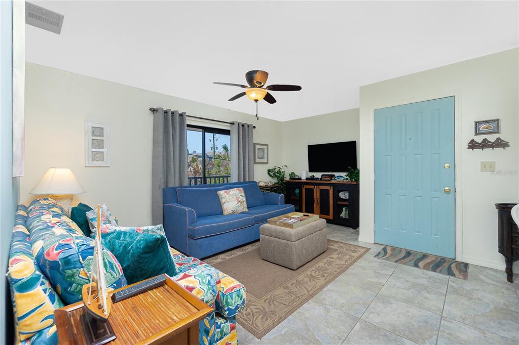 2450 North Beach Road, Unit 231 Englewood, FL 34223 - Photo 4 of 54 a living room with furniture and a flat screen tv