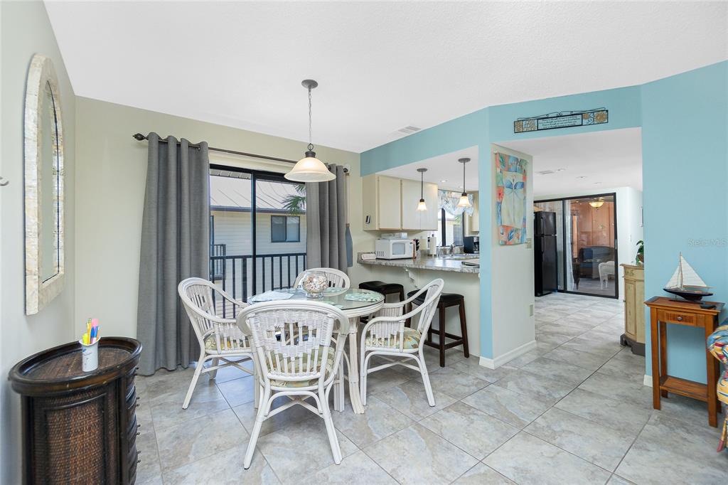 2450 North Beach Road, Unit 231 Englewood, FL 34223 - Photo 8 of 54 a dining room with furniture and window