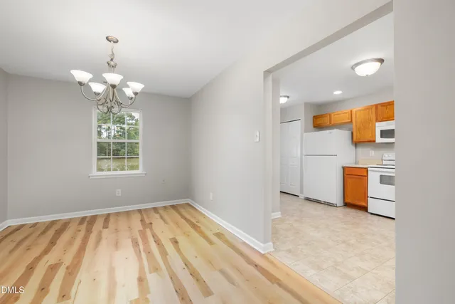 wooden floor in an empty room with a fireplace