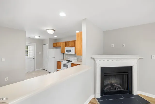 a view of a room with a chandelier and wooden floor