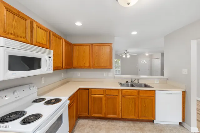 a kitchen with a sink stove and refrigerator