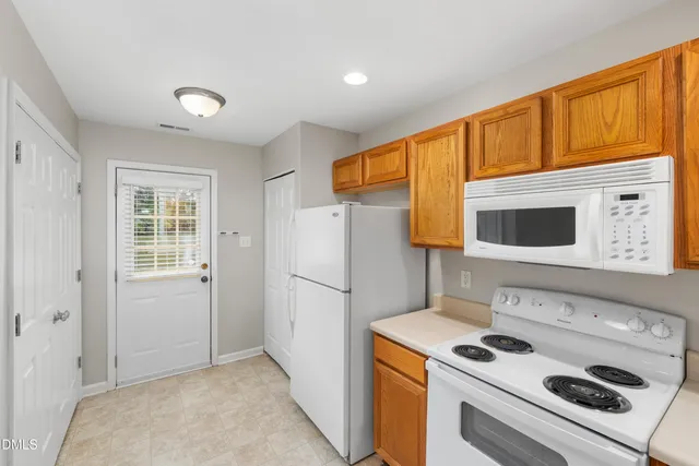 a kitchen with stainless steel appliances granite countertop wooden cabinets a stove top oven a sink and dishwasher