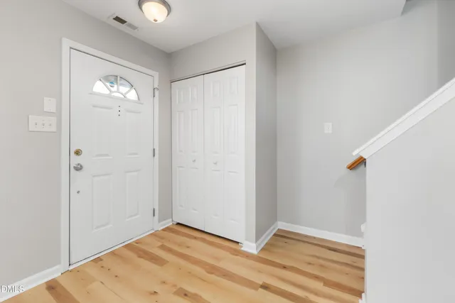 an aerial view of residential houses with outdoor space and lake view