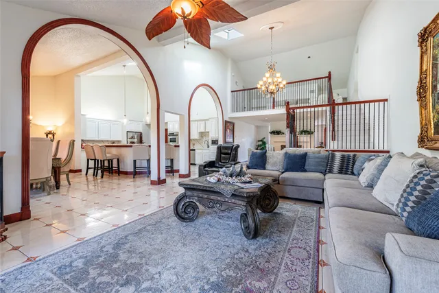 a spacious bedroom with a bed and a flat screen tv