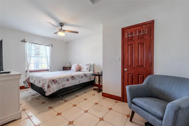 a bedroom with a large bed and a chandelier