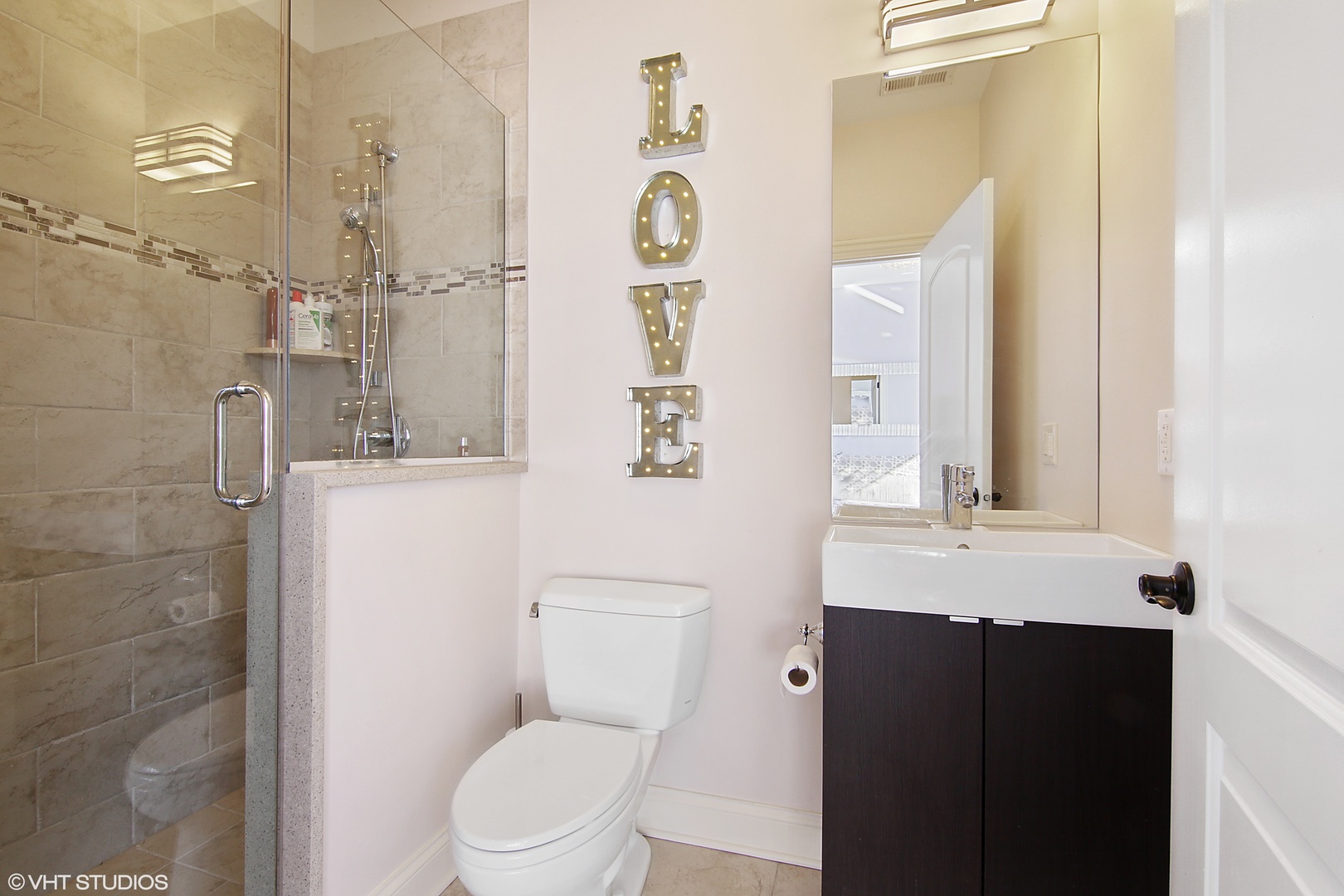 435 Ridge Road Highland Park, IL 60035 - Photo 21 of 30 a bathroom with a granite countertop sink toilet a mirror and shower